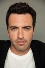 Reid Scott isDr. Dan Lewis